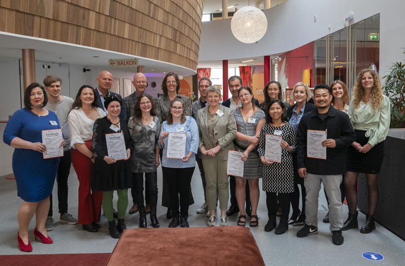 Gruppenbild, auf dem Teilnehmende ihre Zertifikate in den Händen halten